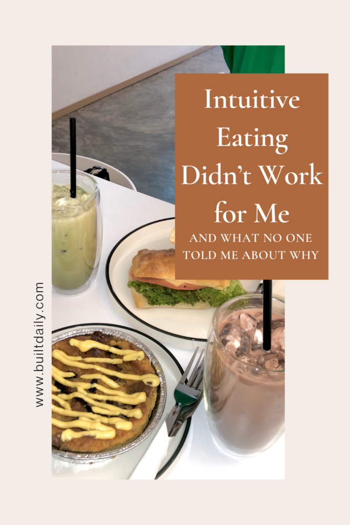 A table with a sandwich, pie, iced matcha, and chocolate drink at a café, overlaid with the text “Intuitive Eating Didn’t Work for Me — And What No One Told Me About Why,” promoting an article on www.builtdaily.com about the challenges of intuitive eating.